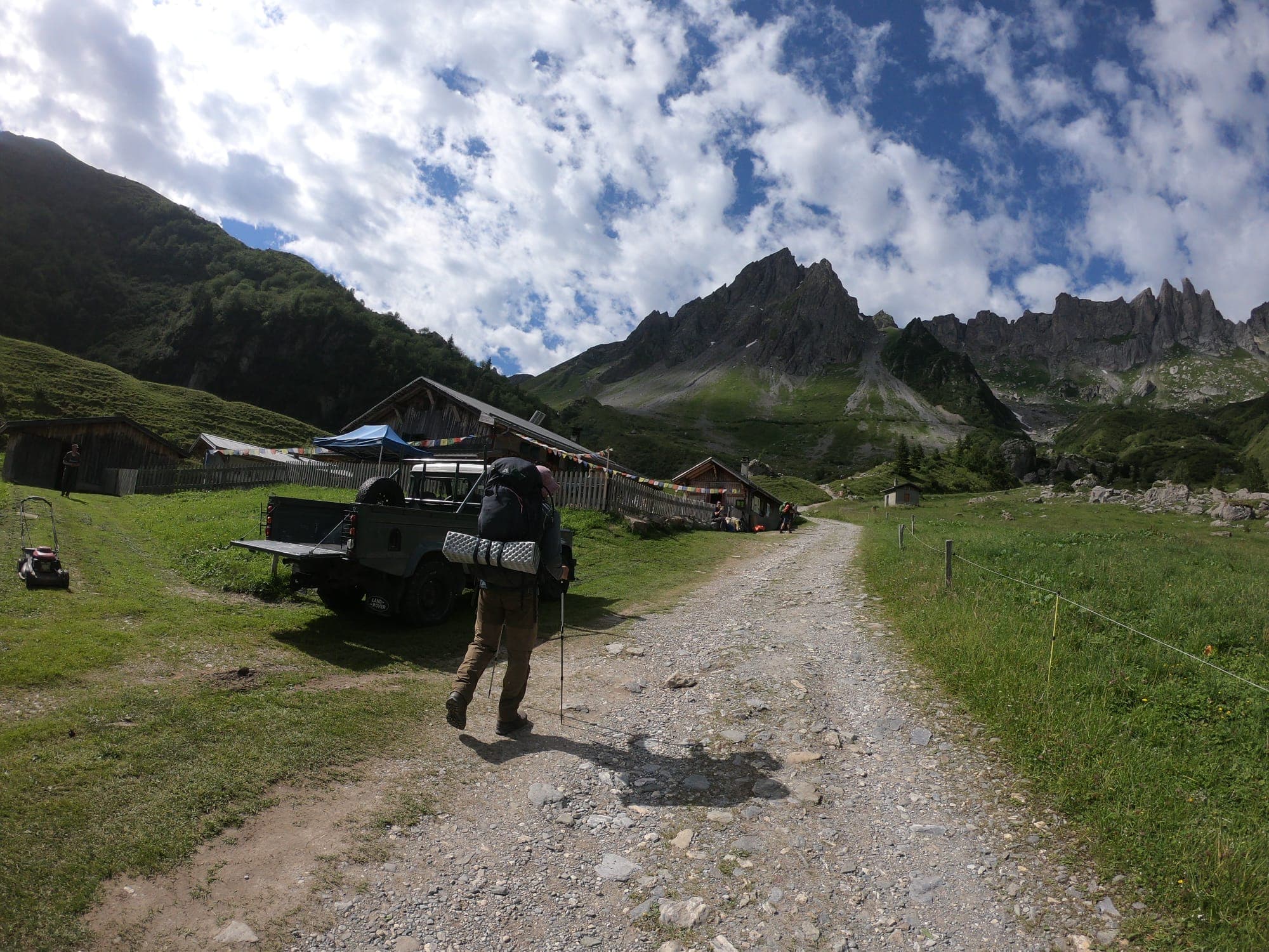 Gravel path on the Tour du Mont Blanc with the Aiguilles de Chamonix and a refuge in view